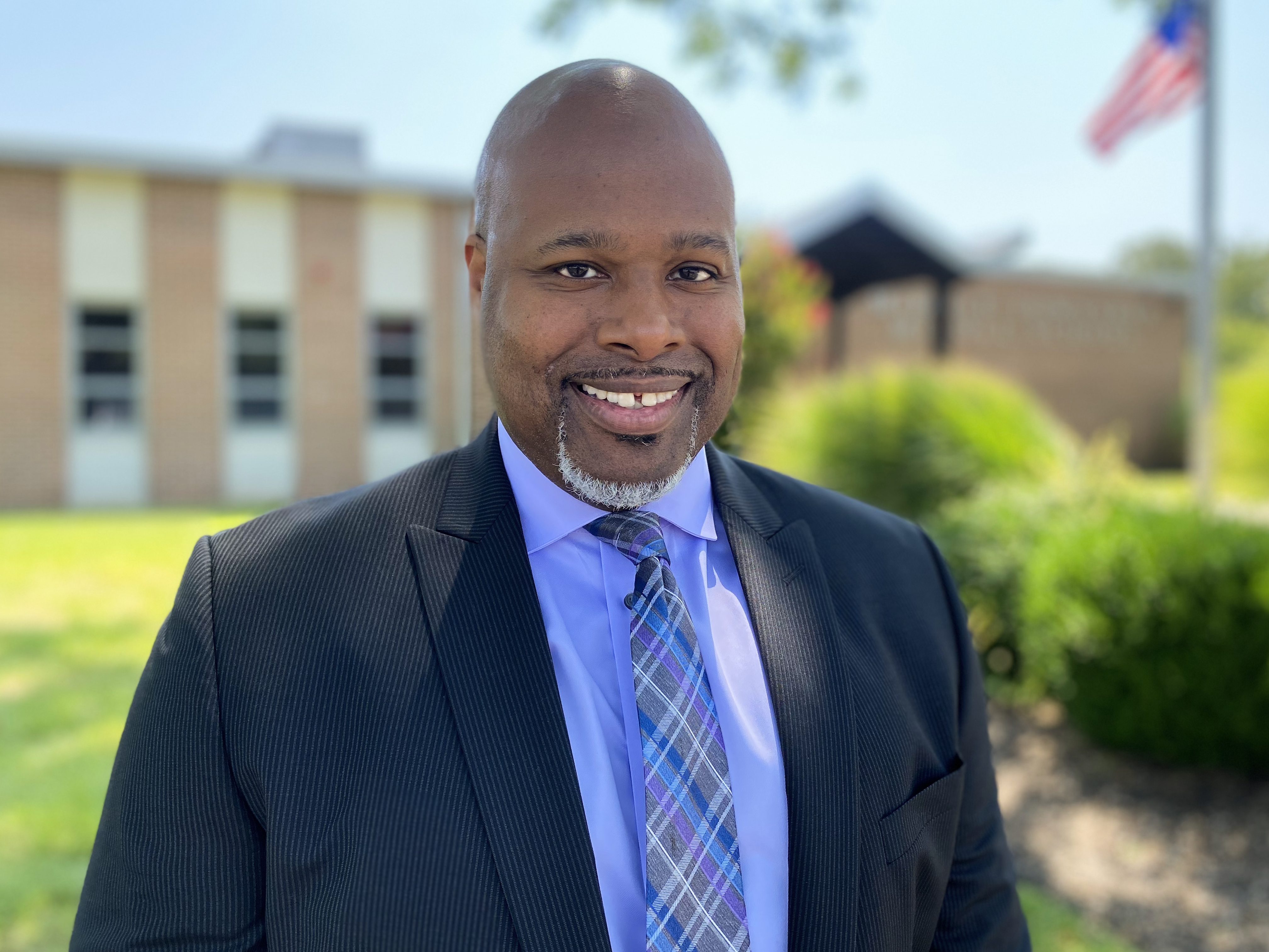 Assistant Principal Andre Hodges posing for a photo outside of the middle school.